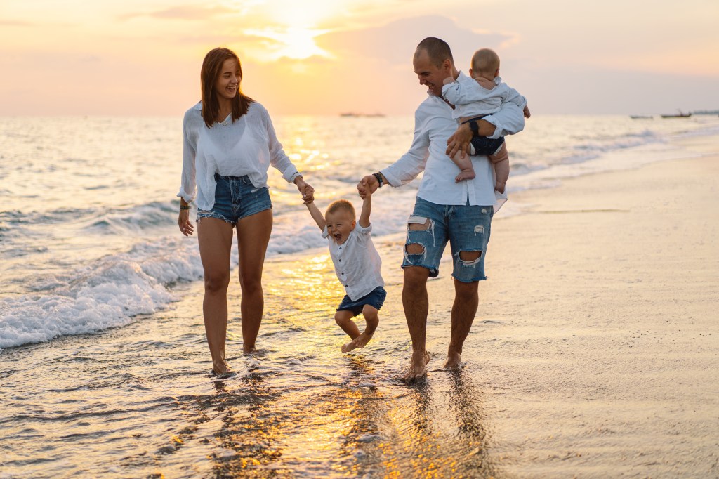 Happy family having fun playing beach on summer beach vacation